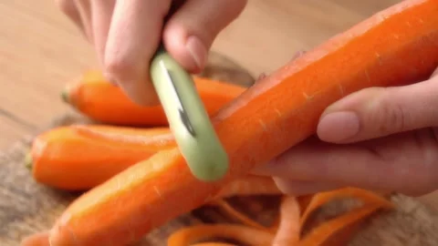 Peeling Fresh Carrot with Peeler. Stock Footage 255665686