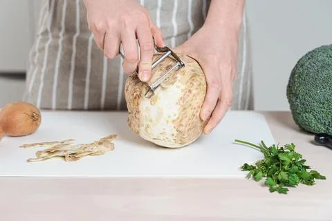 Peeling Fresh Celery Root on White Cutting Board Stock Photos