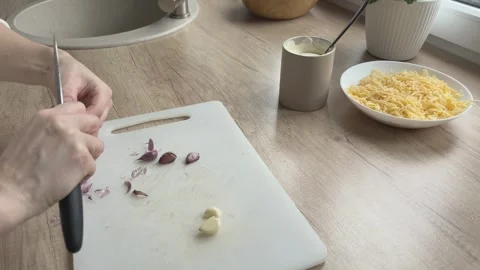 Peeling Garlic Cloves On Cutting Board Preparing Ingredients For Sauce Cooking Video stock 336446605
