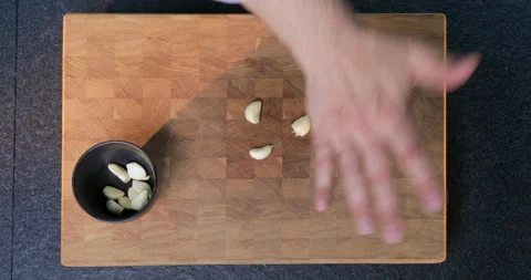 Peeling garlic on a cutting board. Stock Footage 231214450
