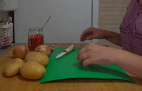 Peeling garlic in the kitchen Stock Photos