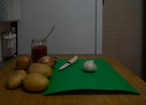 Peeling garlic in the kitchen Stock Photos