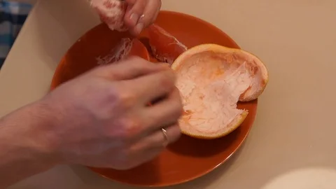 Peeling Grapefruit. Clean the grapefruit Stock Footage 86507439
