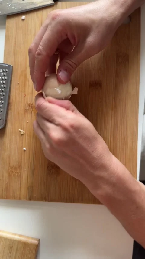 Peeling hard boiled egg by hand on wooden cutting board Stock Footage 337482284