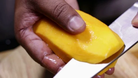 Peeling a KC Mango Video stock 122776972