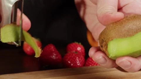 Peeling kiwi with grater close-up. Preparing some fruits for cooking. Health and Stock Footage 260414042