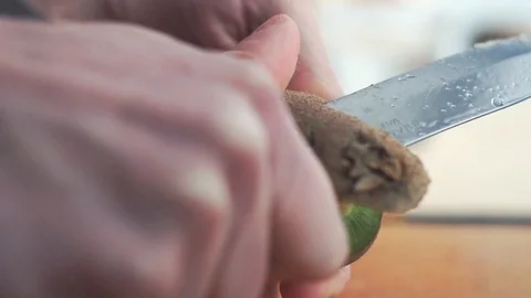 Peeling kiwi in slow motion Stock Footage 86682876