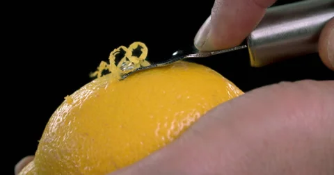 Peeling lemon zest on black background Video stock 55880476