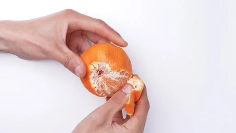 Peeling mandarin orange, 4K video with white background sound. Stock Footage 288787161