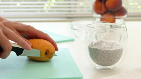 Peeling mangoes. Mango Chia seed layered pudding smoothie Stock Footage 133281171