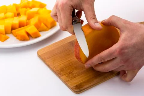 Peeling the middle mango slice with the fruit pit Stock Photos