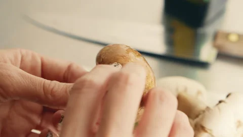 Peeling a Mushroom in Kitchen Stock Footage 134856009