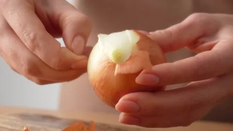 Peeling Onion Layers on Cutting Board Stock Footage 255664212
