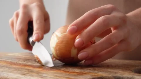 Peeling Onion Layers on Cutting Board Stock Footage 255664300