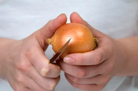 Peeling an onion Stock Photos