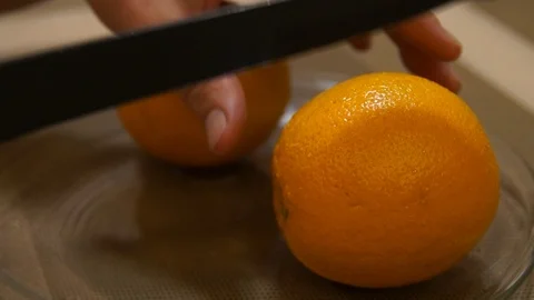 Peeling Orange. Hands with knife peeling fruit. Fresh orange. Cutting orange Stock Footage 99280485