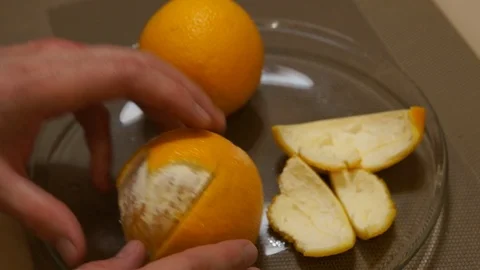 Peeling Orange. Hands peeling fruit. Fresh orange. Healthy food Stock Footage 99280586