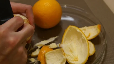 Peeling Orange. Hands peeling fruit. Fresh orange. Healthy food Stock Footage 99391337
