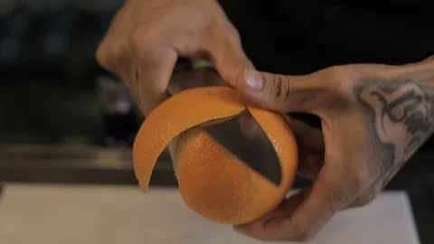 Peeling Orange with Knive Stock Footage 129781642