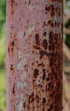 Peeling orange paint on rustic metal surface Stock Photos