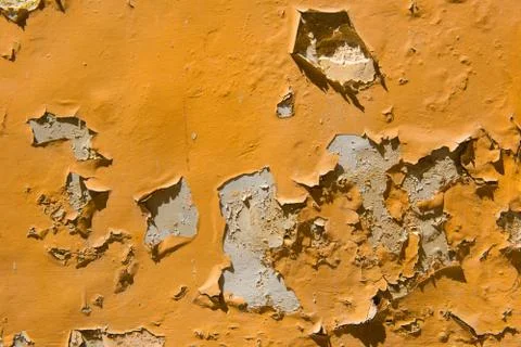Peeling orange paint on a wall Stock Photos