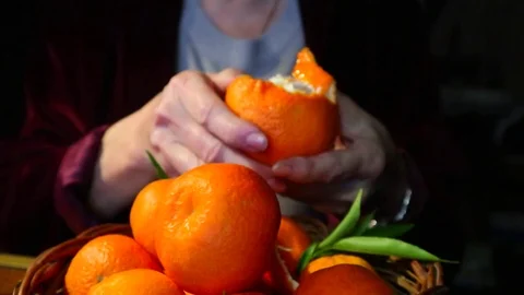 Peeling oranges, tangerines, preparing for eating. Stock Footage 102034454