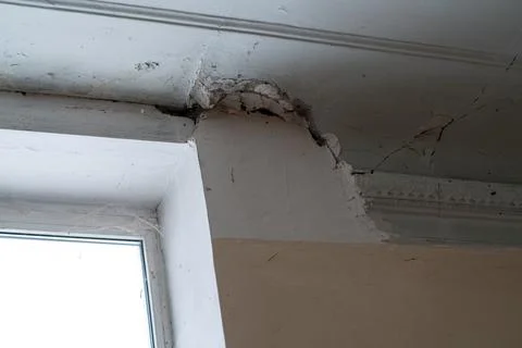 Peeling paint on an interior ceiling a result of water damage caused by a l.. Stock Photos