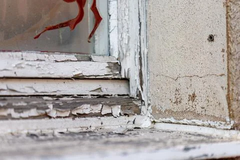 Peeling paint on an old weathered window frame Stock Photos