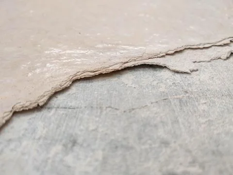 Peeling paint on a wall surface reveals the underlying layer Stock Photos