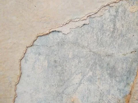 Peeling paint on a wall surface reveals the underlying layer Stock Photos
