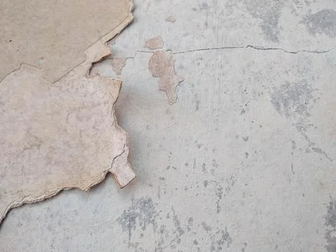 Peeling paint on a wall surface reveals the underlying layer Stock Photos