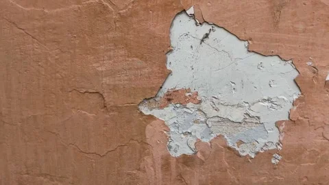Peeling paint on the wall. Weathered rough painted surface Stock Footage 256028408