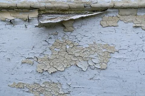 Peeling paint on weathered surface with cracks and texture Stock Photos