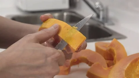 Peeling a Papaya fruit. Stock Footage 77738789