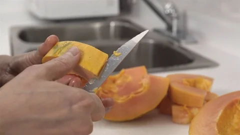 Peeling a Papaya fruit. Stock Footage 77739247