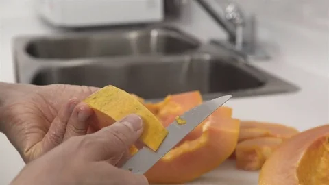 Peeling a Papaya fruit. Stock Footage 77739396