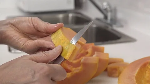 Peeling a Papaya fruit. Stock Footage 77739510