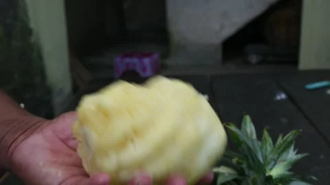 Peeling a Pineapple or Ananas comosus with knife. Stock Footage 318741648
