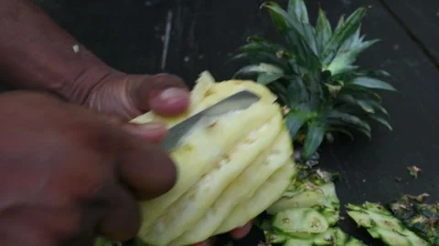 Peeling a Pineapple or Ananas comosus with knife. Stock Footage 318742222
