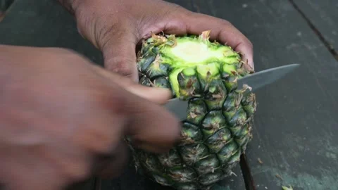 Peeling a Pineapple or Ananas comosus with knife. 스톡 동영상 318742502