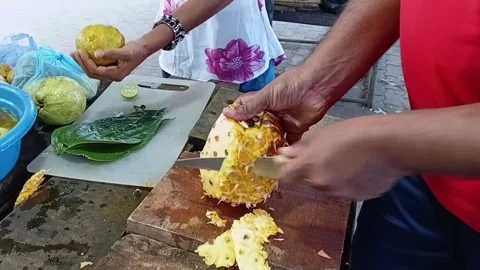 Peeling Pineapple with Sacred Bael Fruit for Sri Lankan Puja Stock Footage 339058925