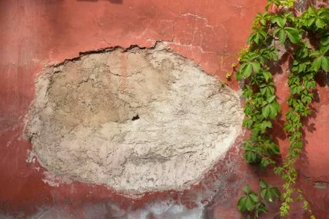 Peeling plaster in an ancient wall Stock Photos