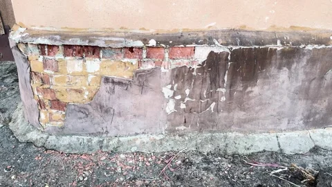 Peeling plaster on damaged brick wall, texture of crumbling building facade Stock Footage 331331994