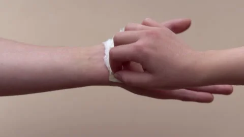 Peeling off the plaster from a man's hand. A sore or wound on the arm. Wound Stock Footage 154407371