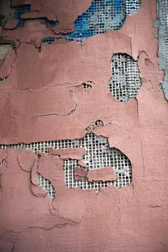 Peeling plaster wall with exposed mesh texture Stock Photos