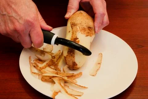 Peeling a potato 스톡 사진