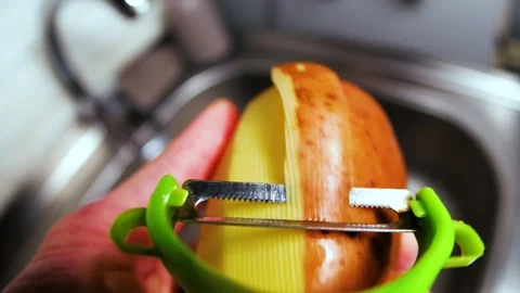 Peeling potatoes close up in the kitchen Video stock 263153242
