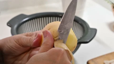 Peeling potatoes with a knife Stock Footage 217973056