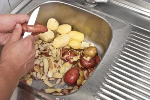 Peeling potatoes Stock Photos