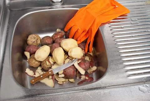Peeling potatoes Stock Photos